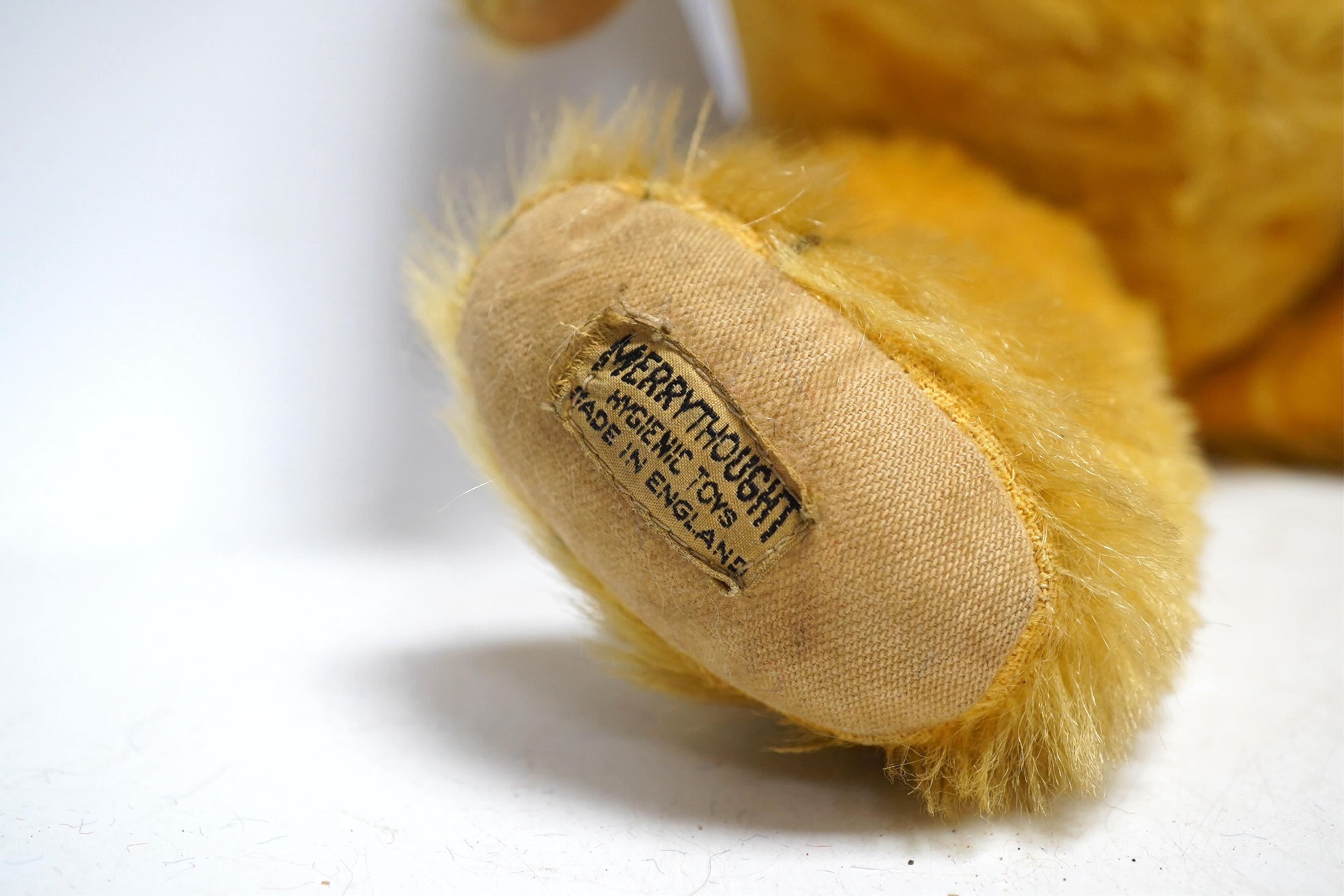 A large Chad Valley bear, c.1930's, label on foot, hair loss, restored paw pads, 69cm high, a Chad Valley red, white and blue unjointed bear, c.1950's, 60cm high, and a Merrythought bear c.1930's, label on foot, slight h